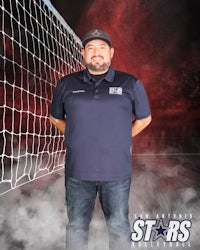 a man standing in front of a volleyball net