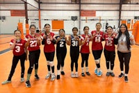 a group of volleyball players posing for a picture