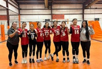 a group of volleyball players posing for a picture