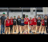 a group of volleyball players posing for a picture